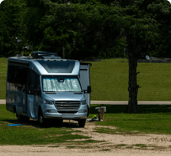 Camper van parked on grassy field