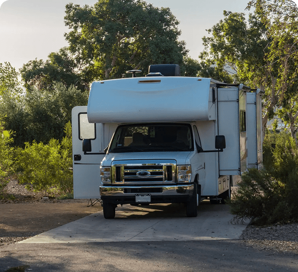 Camper van at a forested campsite