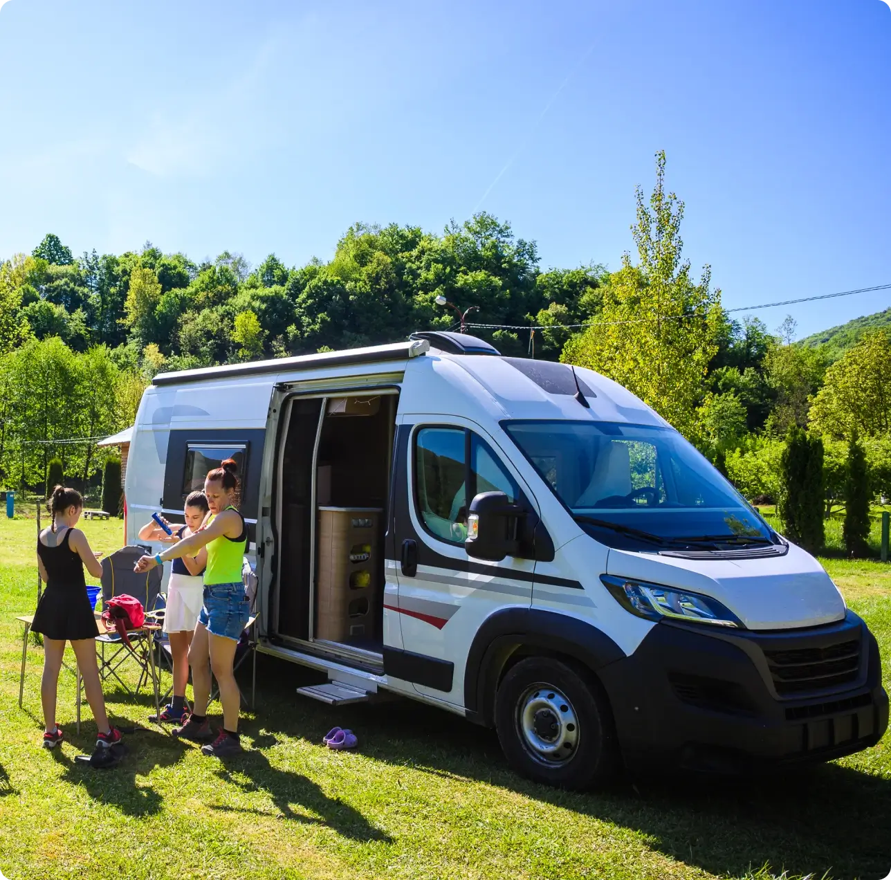 Outdoor family gathering near camper van