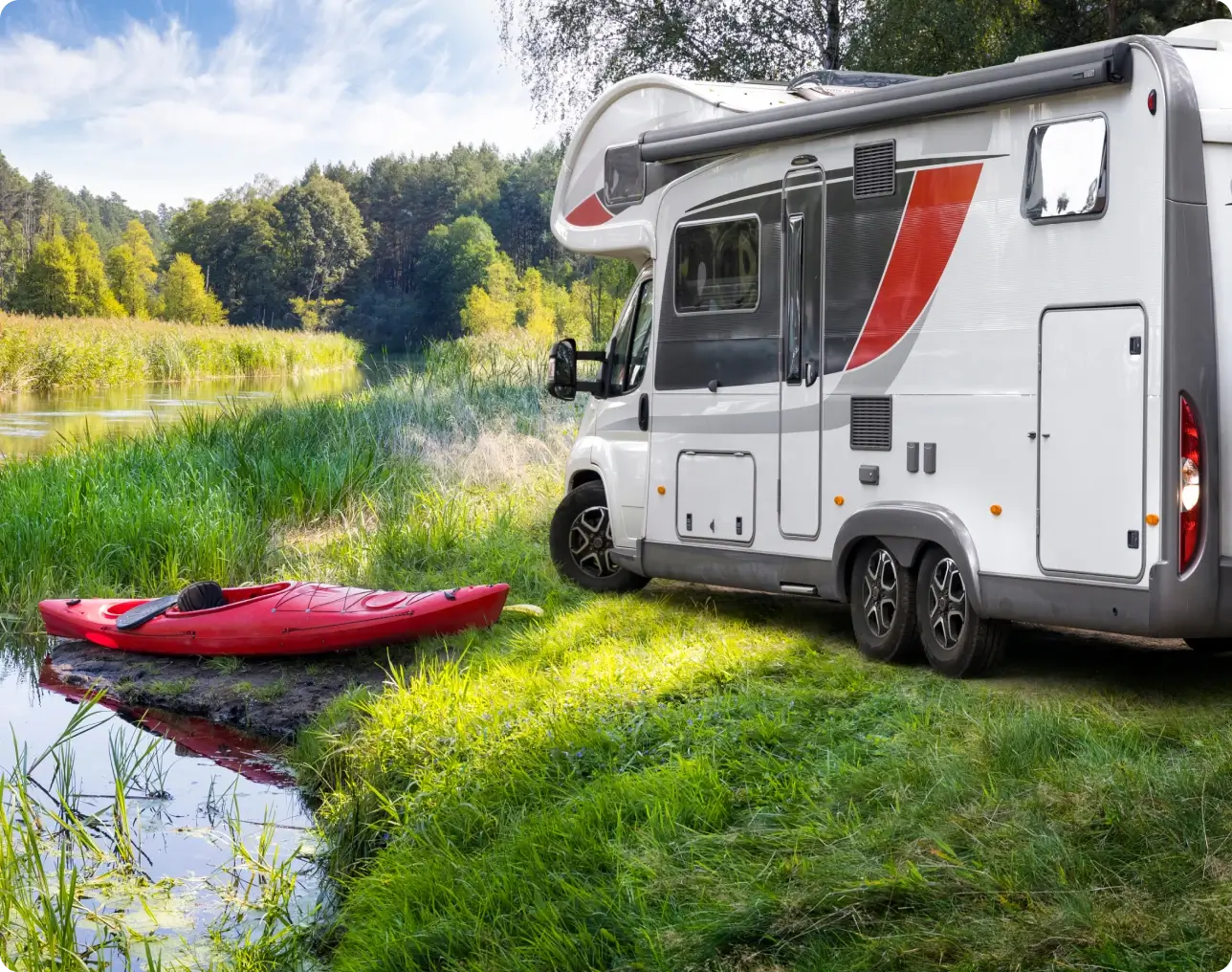 Red kayak next to campervan
